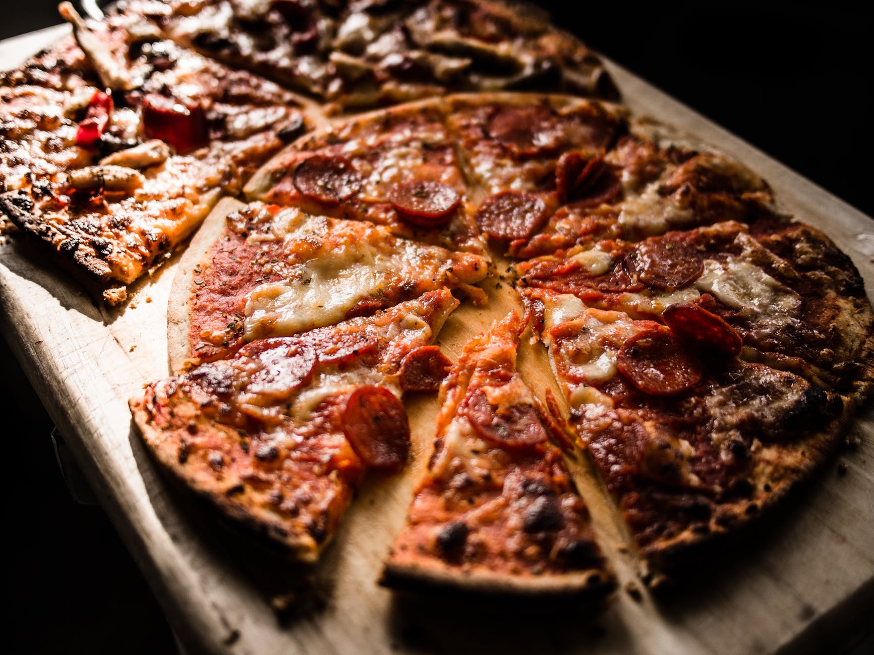 pizza on brown wooden board