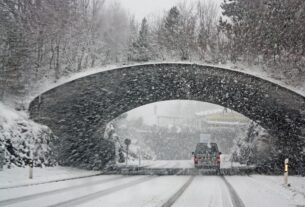 photo of white vehicle crossing a tunnel