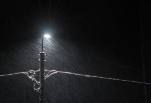 black electric lamp post with lighted lamp during nighttime