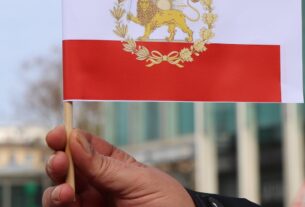a person holding a lion and sun iranian flag