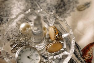 clock and accessories in a clear bowl